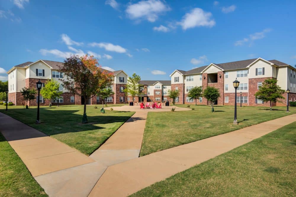 mustang village off campus apartments near midwestern state university msu courtyard fire pit and lounge seating